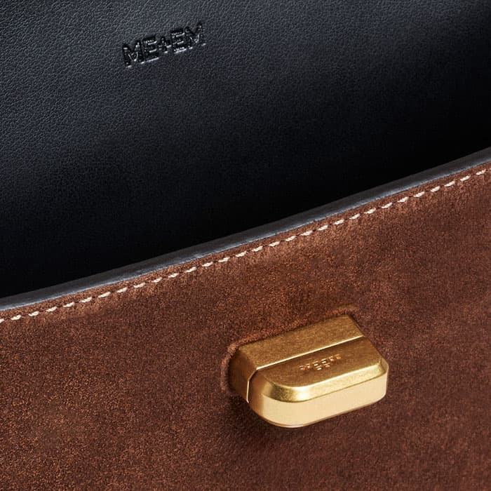 The gold-plated twist-and-lock fastening is elevated with bespoke branding.