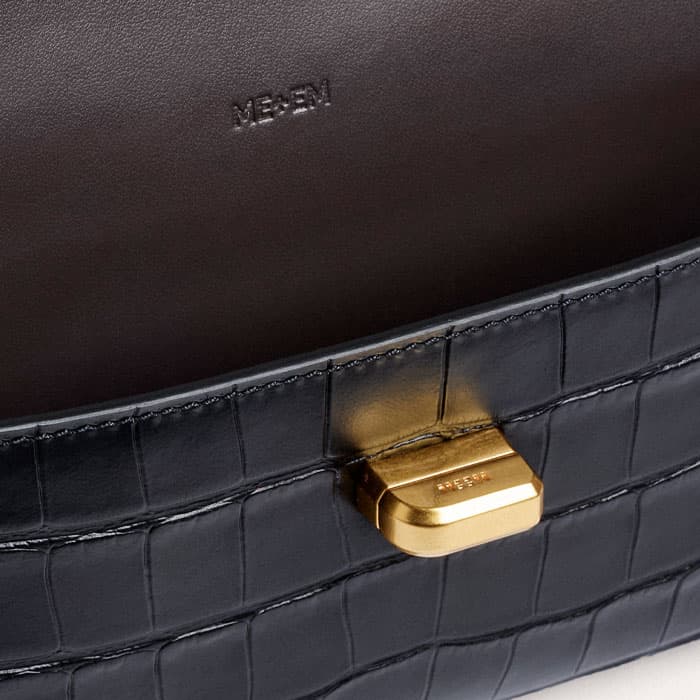 The gold-plated twist-and-lock fastening is elevated with bespoke branding.