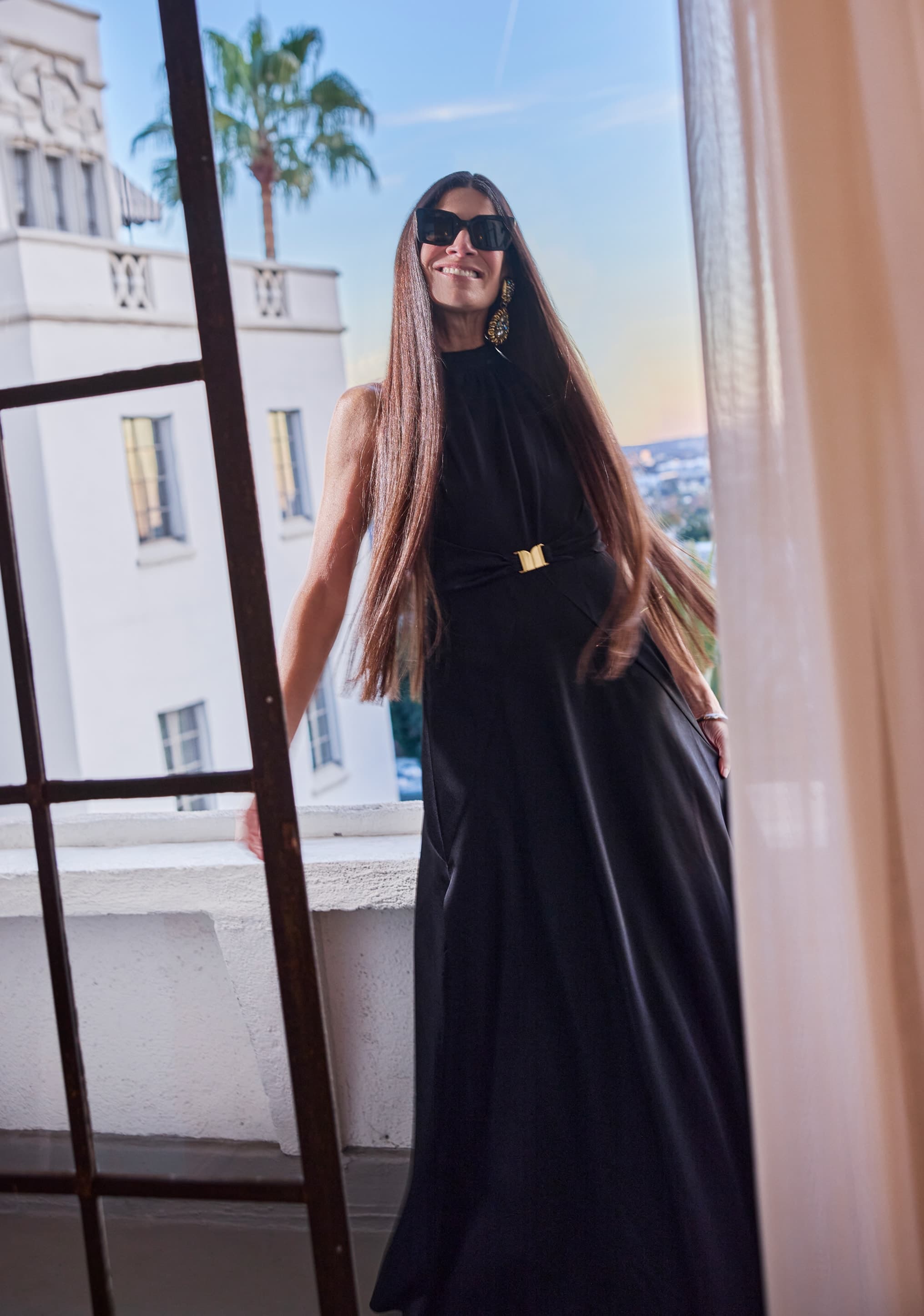 Elizabeth Saltzman stood on a balcony with a view of LA in the background.