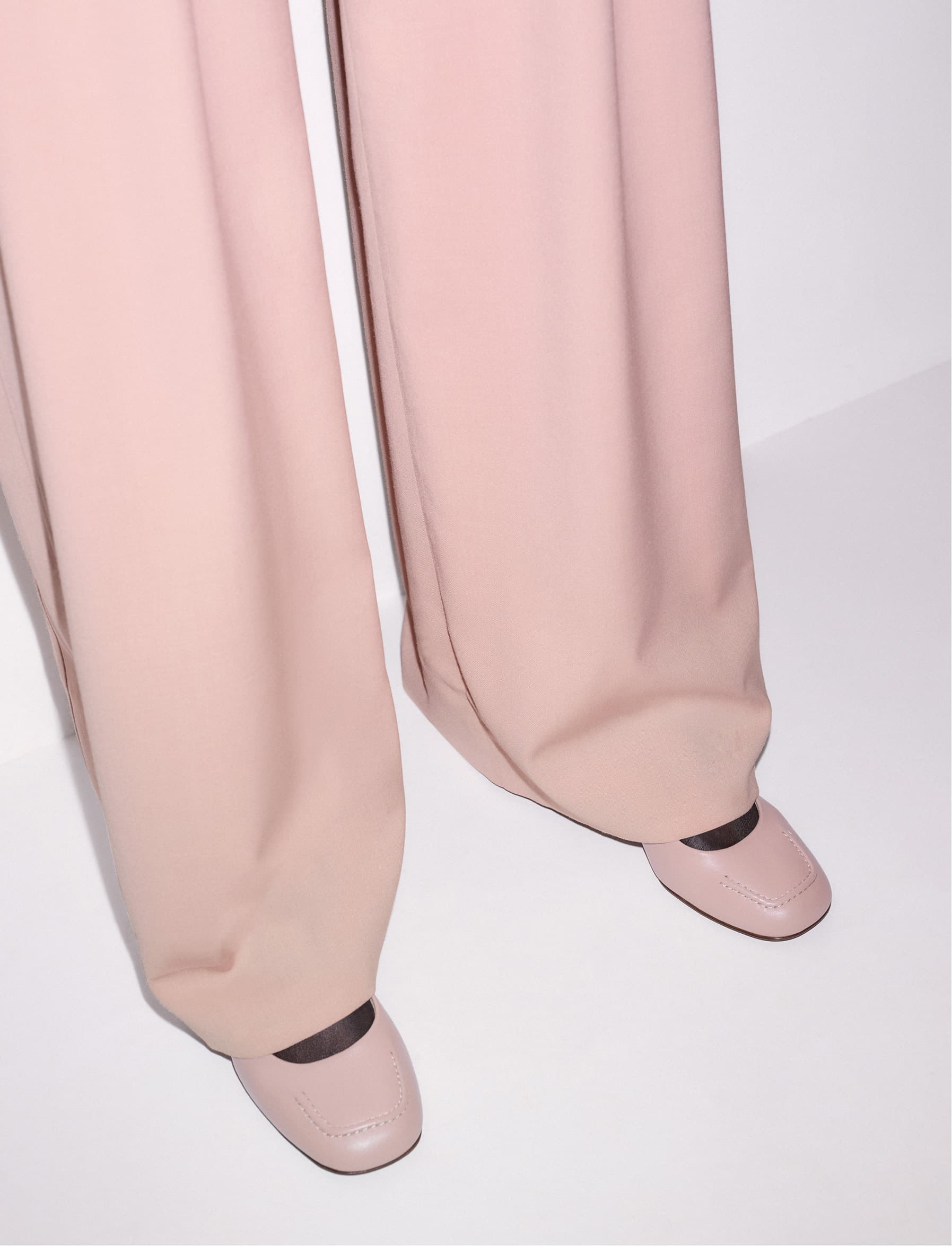 Shot of models legs in a pair of pink pants and pink shoes.