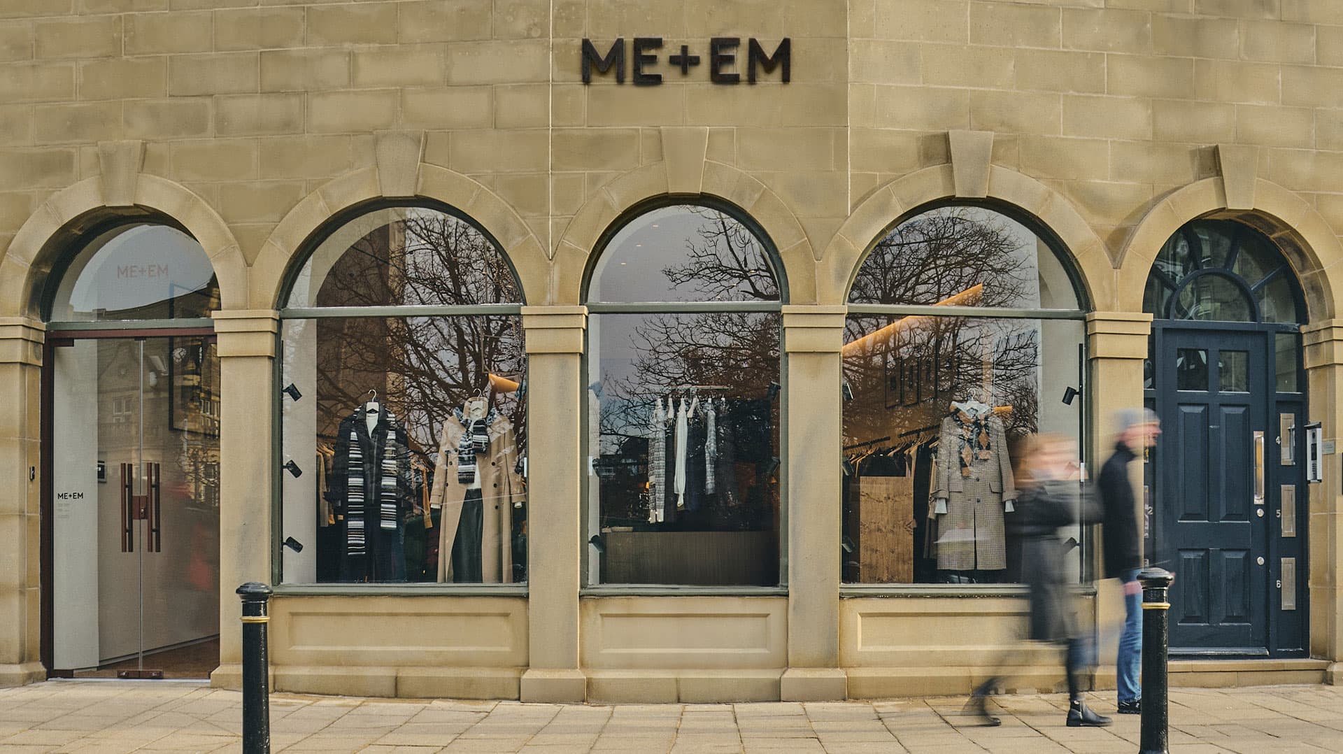 ME+EM Harrogate store front with brick work and clothes hanging in windows