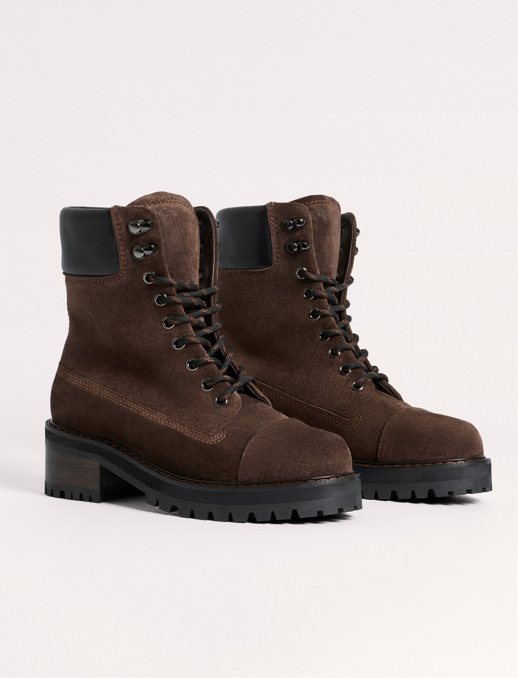 A pair of brown suede hiking style boots.