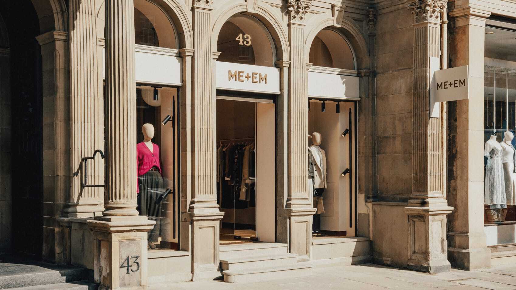ME+EM Edinburgh store front with light brick work and mannequins in window