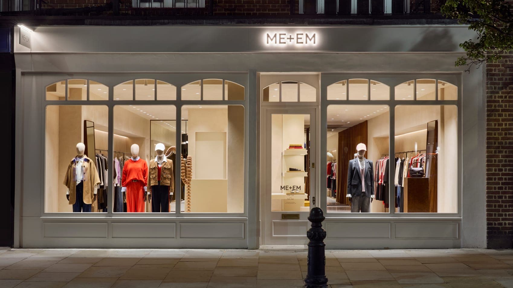 ME+EM Kings Road at night with lights on and clothes in windows