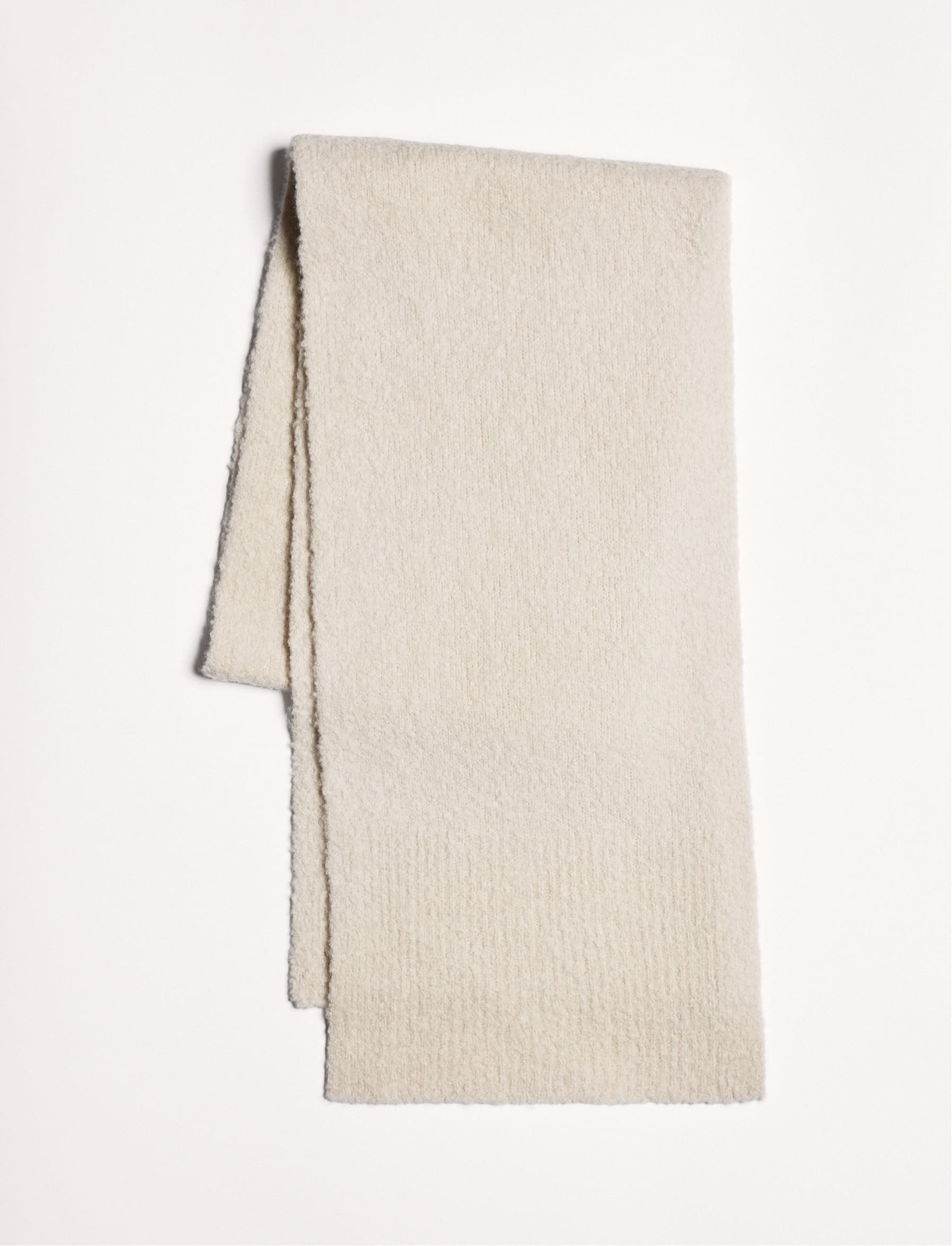 A folded cream scarf.