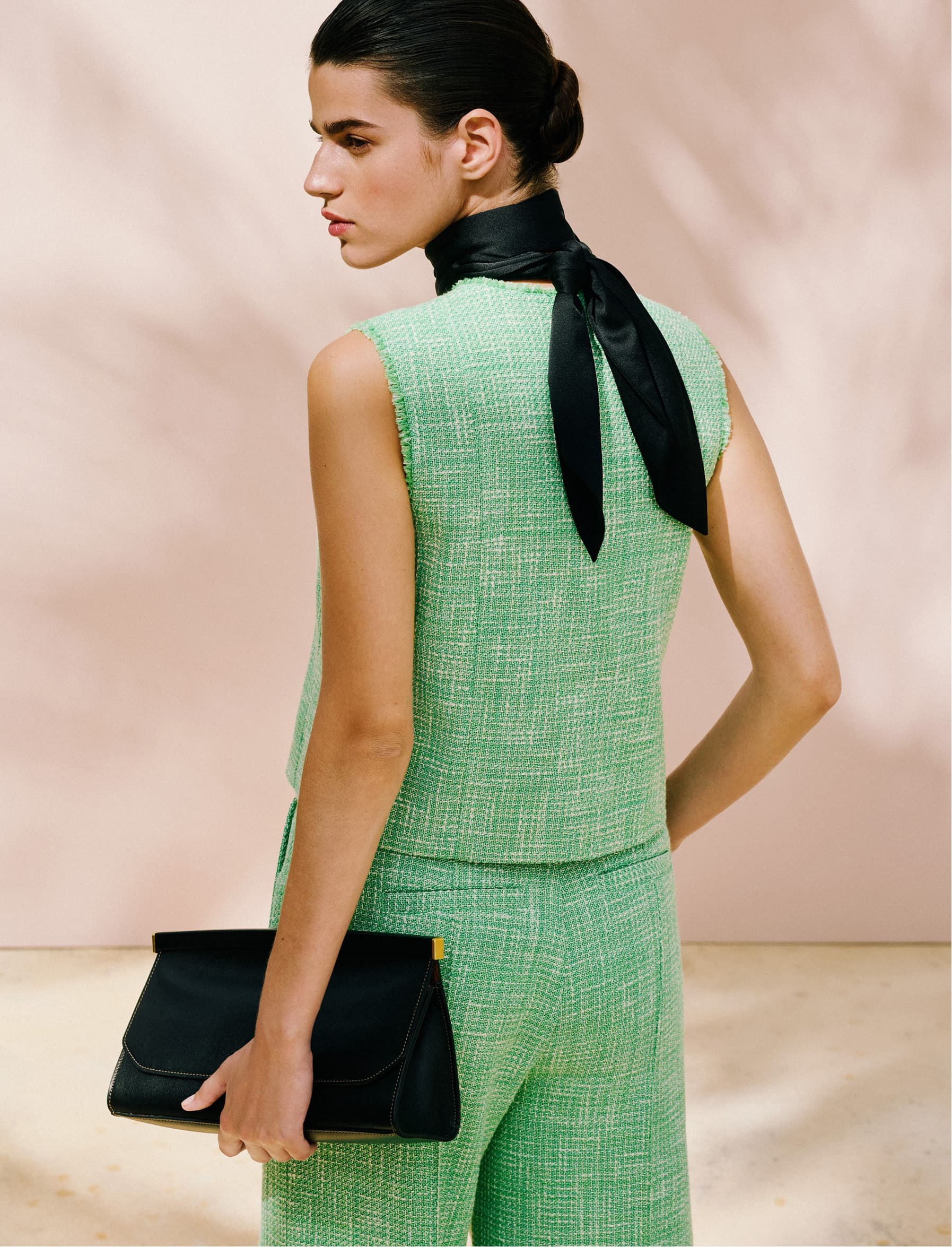 Back of a model posing in a green co-ord.